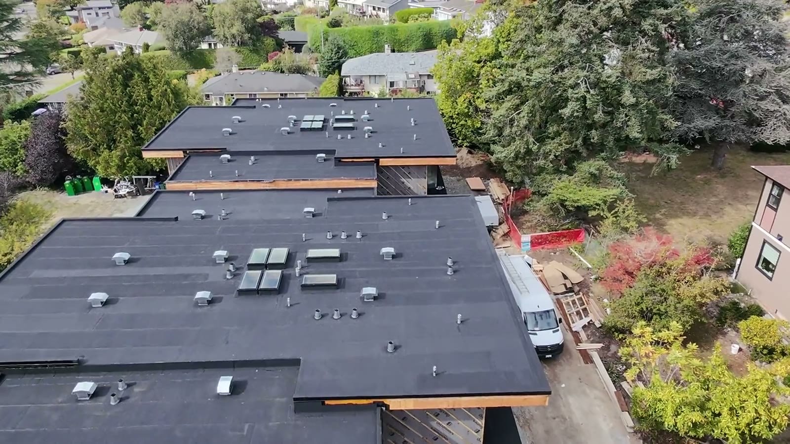Aerial view of a completed flat torch-on membrane roof by Innovation Roofing