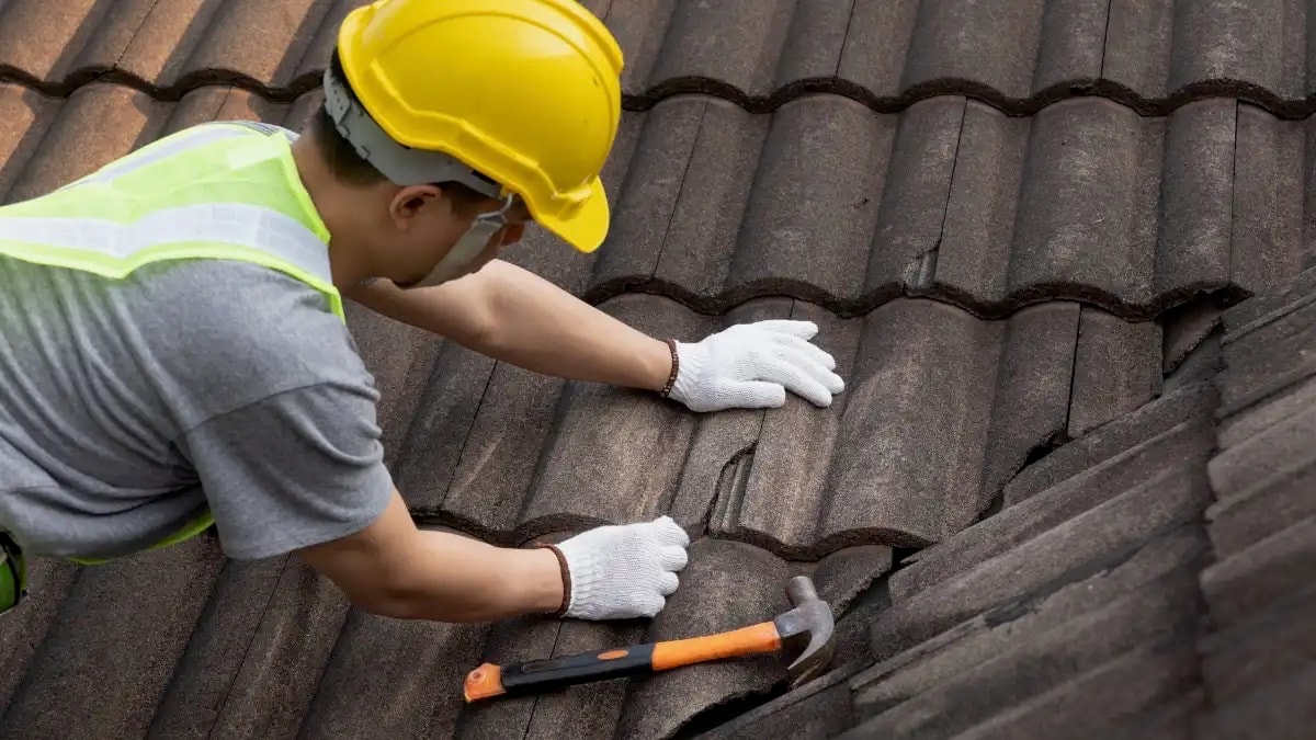 Roofer repairing a damaged roof during an emergency call-out